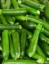 A pile of fresh, baby zucchini, showcasing their vibrant green color.