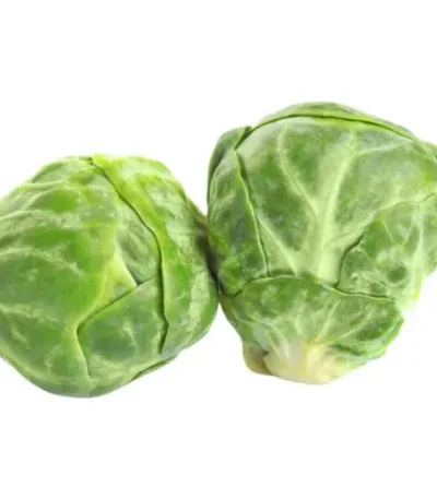 Two fresh Brussels sprouts on a white background, highlighting their green, leafy texture.